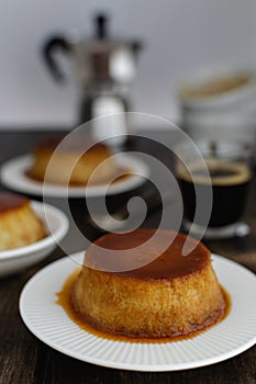 Caramel flan, crema catalana dessert on dark brown woden table