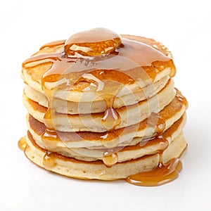 Caramel glazed pancakes stack isolated on white background photo