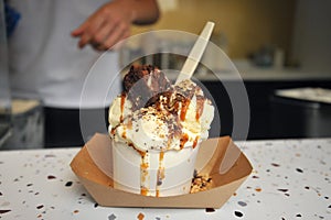 Caramel ice cream with brownie sold in a small shop in London , Uk