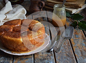 Caramel monkey bread. Apple pie with brown sugar and cinnamon on a wooden background. Autumn baking. Homemade sweets. Rustic style