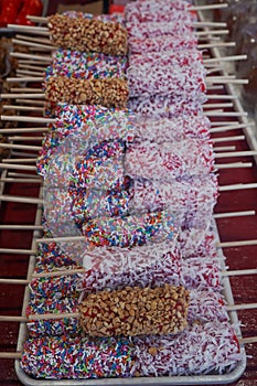 Caramel peanut marshmallow, red candy marshmallow with white coconut and marshmallow with rainbow sprinkles