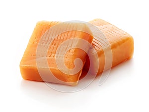 Caramel pieces on white background