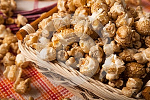 Caramel popcorn in a basket on a napkin