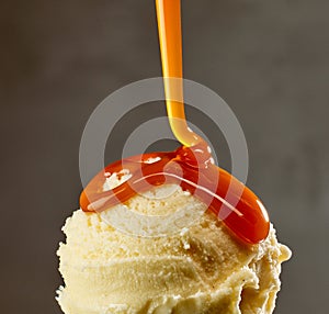 caramel sauce flowing on vanilla ice cream