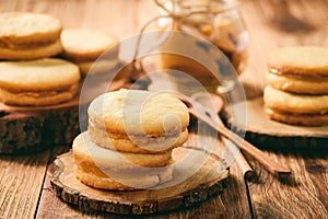 Caramel shortbread cookies on wooden background.