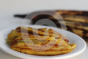 Caramelised plantain slices. Long slices of ripe plantain roasted with ghee and sugar on a griddle. A traditional tea time snack