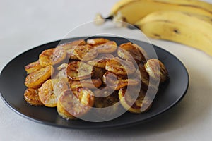 Caramelised plantain slices. A traditional tea time snack from Kerala.Cut ripe plantain into slices and toast it in a pan adding