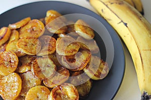 Caramelised plantain slices. A traditional tea time snack from Kerala.Cut ripe plantain into slices and toast it in a pan adding