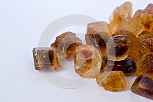 Caramelized cane sugar cubes on white