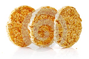 Caramelized corn cakes. Puffed whole grain crispbread isolated on white background. Close-up