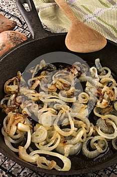 Caramelized onion rings in a cast iron pan