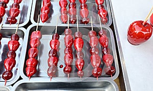 caramelized red apple and strawberries for sale at kiosk