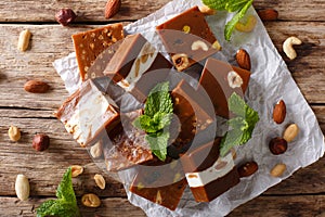 Caramelized toffee with various nuts close-up on the table. Horizontal top view