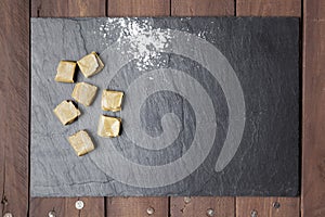 Caramels and sugar on slate plate