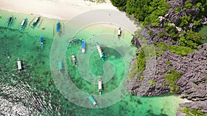 Caramoan Islands, Camarines Sur, Matukad. Philippines. Boats and tourists on the beach.