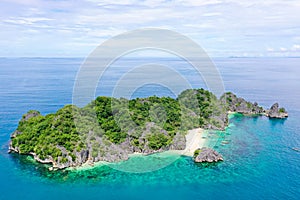 Caramoan Islands, Matukad , Philippines. Boats and tourists on the beach.