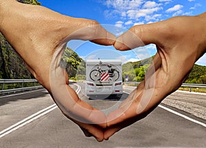 Caravan car on the road love travellng hands fingers like heart  a love background