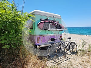 caravan car by the sea bikes surf surfing beach umbrellas trees in summer