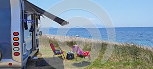 Caravan car by the sea in summer beach trees blue sky