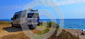 Caravan car by the sea in summer beach trees blue sky