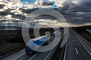 Caravan or convoy of lorry trucks on country highway