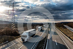 Caravan or convoy of lorry trucks on country highway