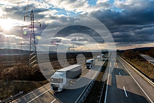 Caravan or convoy of lorry trucks on country highway