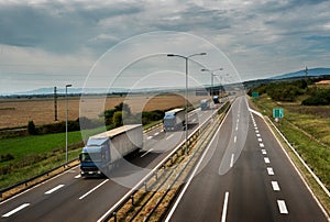 Caravan or convoy of lorry trucks on highway photo