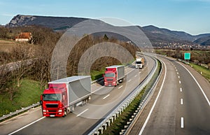 Caravan or convoy of trucks on highway