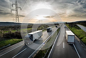 Caravan or convoy of trucks on highway