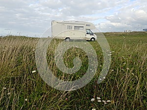 Caravan on the meadow in a cloudy day