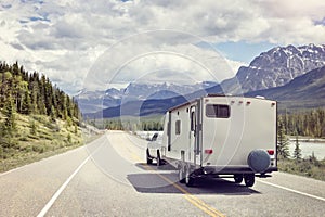 Caravan or motor home trailer on a mountain road photo