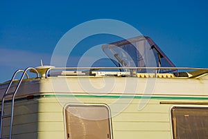 Caravan with open sunroof, raisable window on roof top