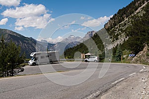 Caravan on the road in the Alps