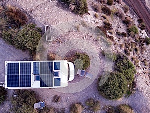 Caravan with solar panels on roof on sea, Spain. Aerial view