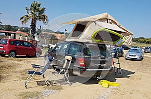 Caravan tent on the top of the car by the beach photo