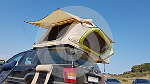 Caravan tent on the top of the car by the beach photo