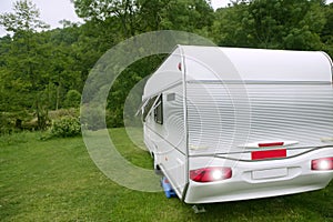 Caravan van in the green meadow camping