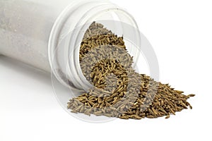 Caraway seeds spilling from container
