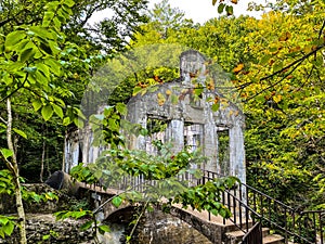 Carbide Willson Ruins and a bridge in a lush green forest, Gatineau Park, Chelsea, Quebec, Canada