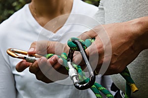 Carbines and rope for climbing in hands