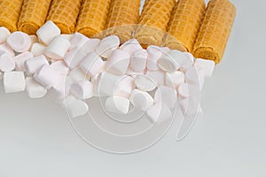 Carbohydrate sweets, waffle tubes and marshmallow, macro food photography