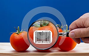 Carbon footprint bar code label on tomato magnified, food customer sustainability label