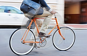 Carbon-free commuting. a man riding his bicycle through the city.