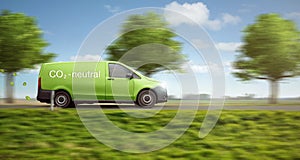 Carbon-neutral delivery with a green van driving on a country road with green trees