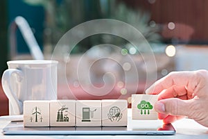 Carbon neutrality and net zero concepts. Hand-place wooden cubes bearing the netzero symbols for carbon emission reduction, photo