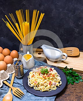 Carbonara Spaghetti with ingredients and tools photo
