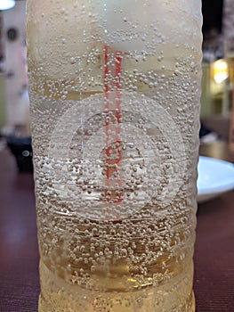 carbonated drink in a glass glass with a straw closeup photo