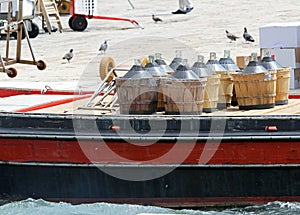 carboys full of wine carried in a boat