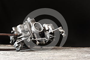 Carburetor on wooden surface photo